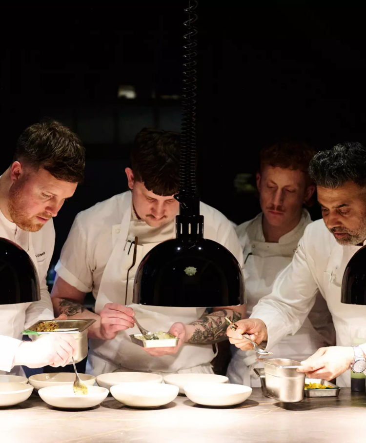 Four chefs working on the pass