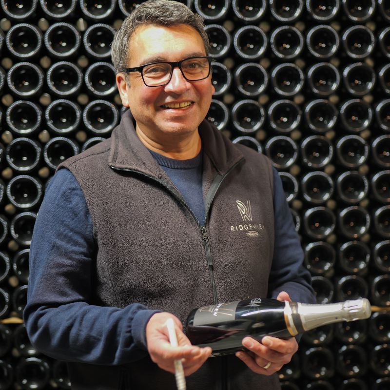 Head winemaker signing a bottle in the cellar