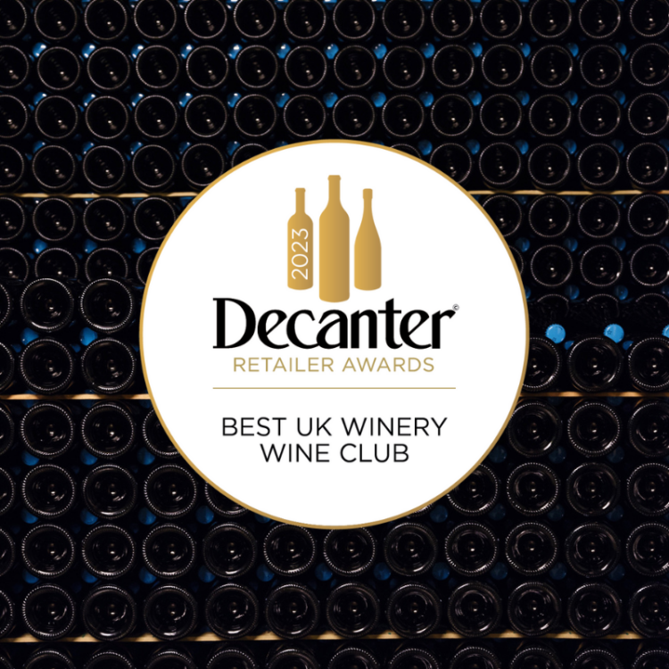 Bottles resting in our cellar overlaid with the award medal for Decanter's Best UK Winery Wine Club