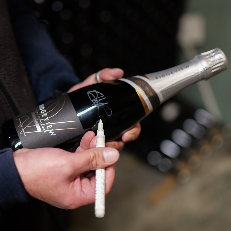 Winemaker signing one bottle