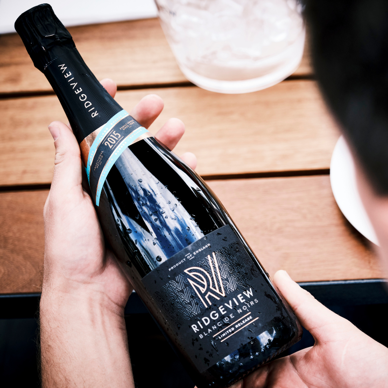 A birds eye view of someone holding a bottle over a table